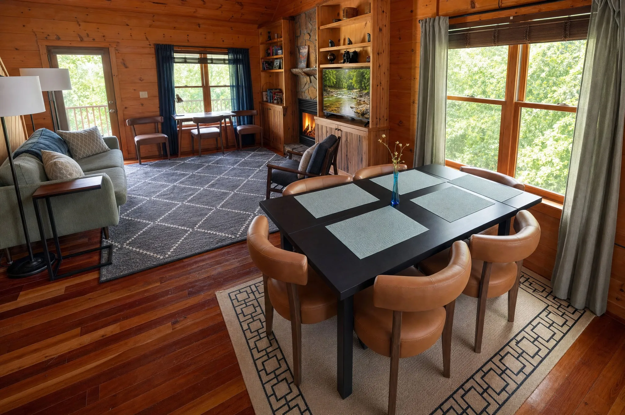 Dining table beside the great room windows and fireplace