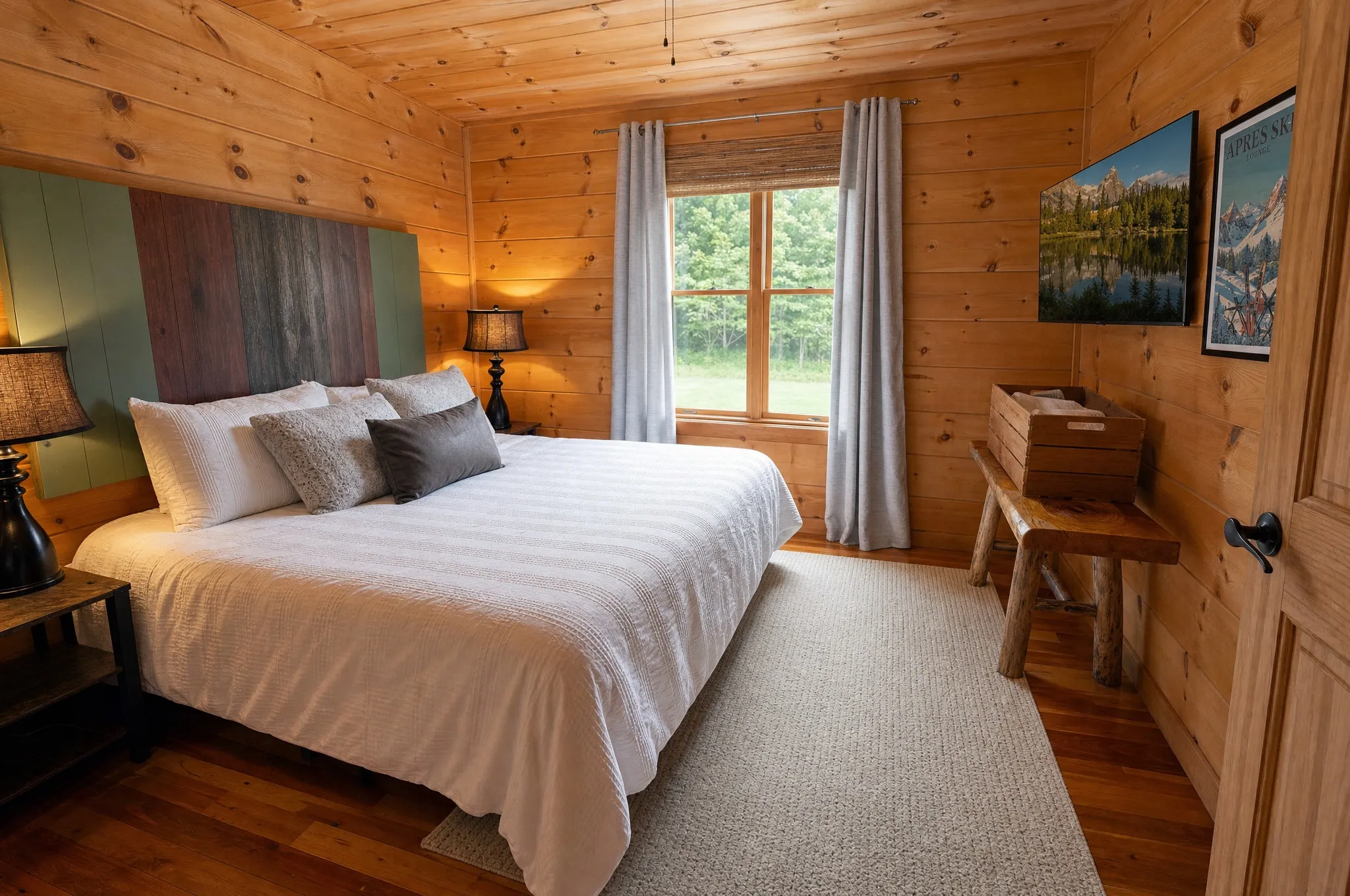 King bed beside a bright window in the main-level bedroom