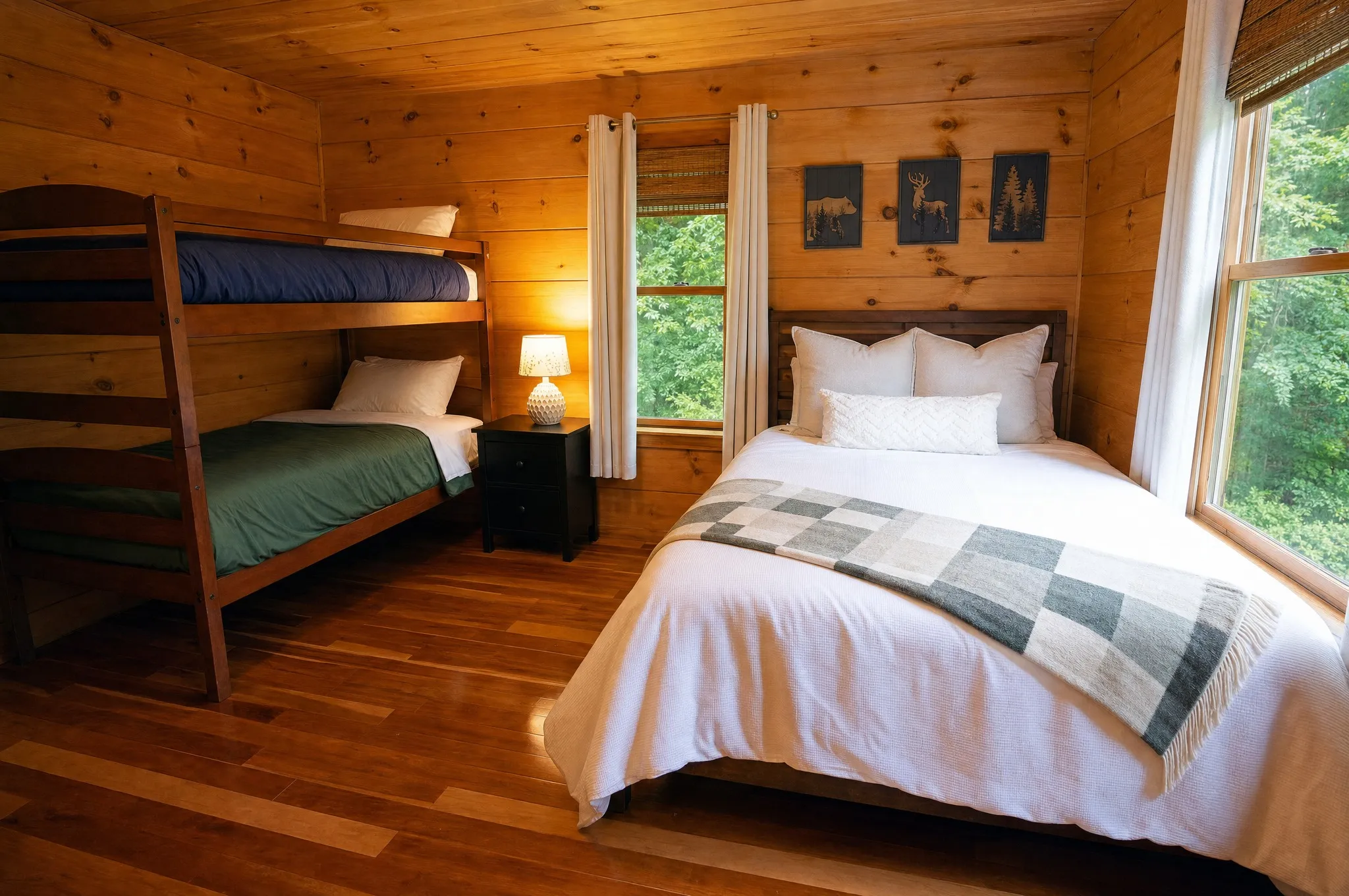 Main-level bedroom with a queen bed and twin bunk beds