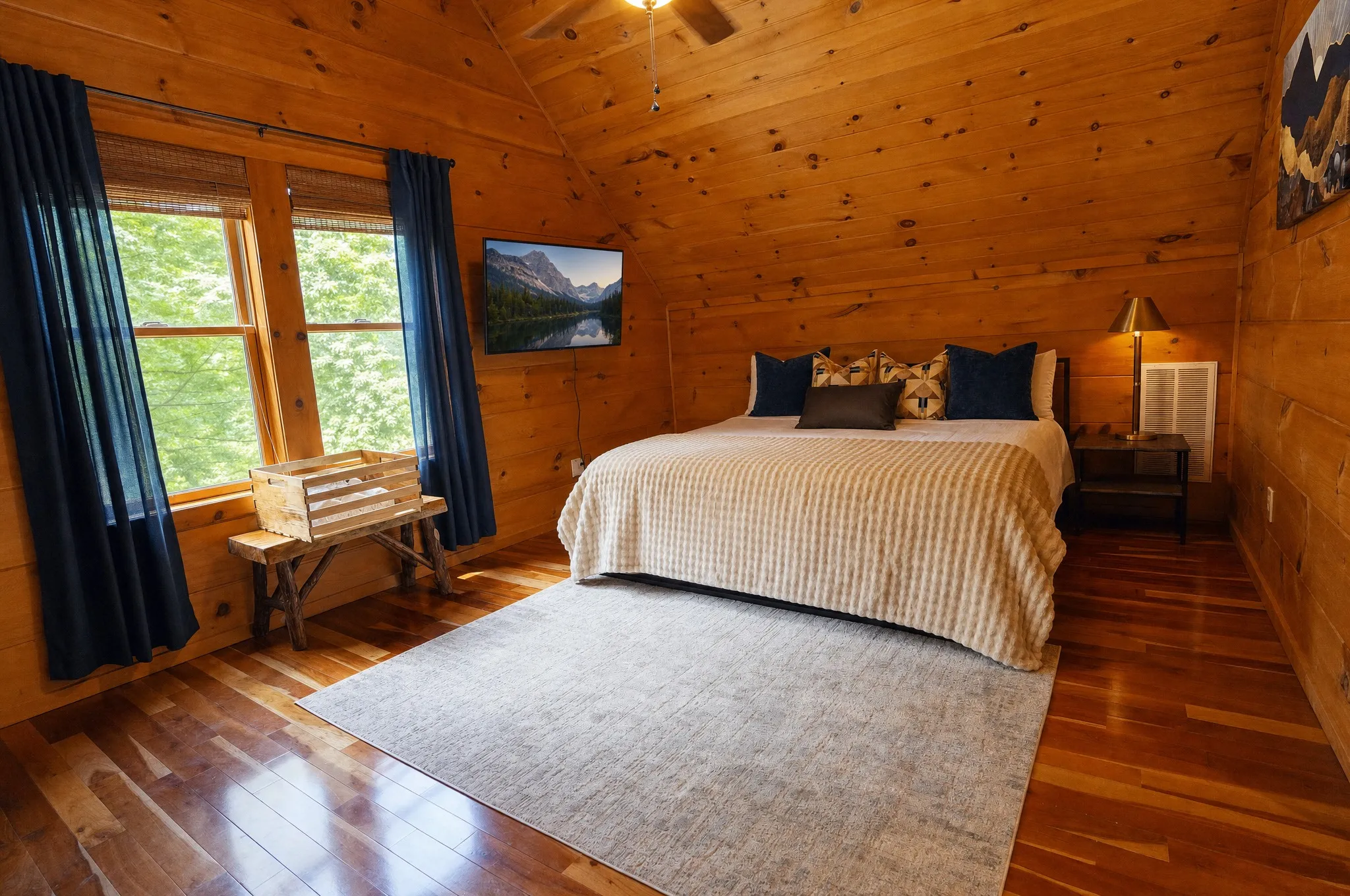Upper-level primary suite with a king bed and reading chair