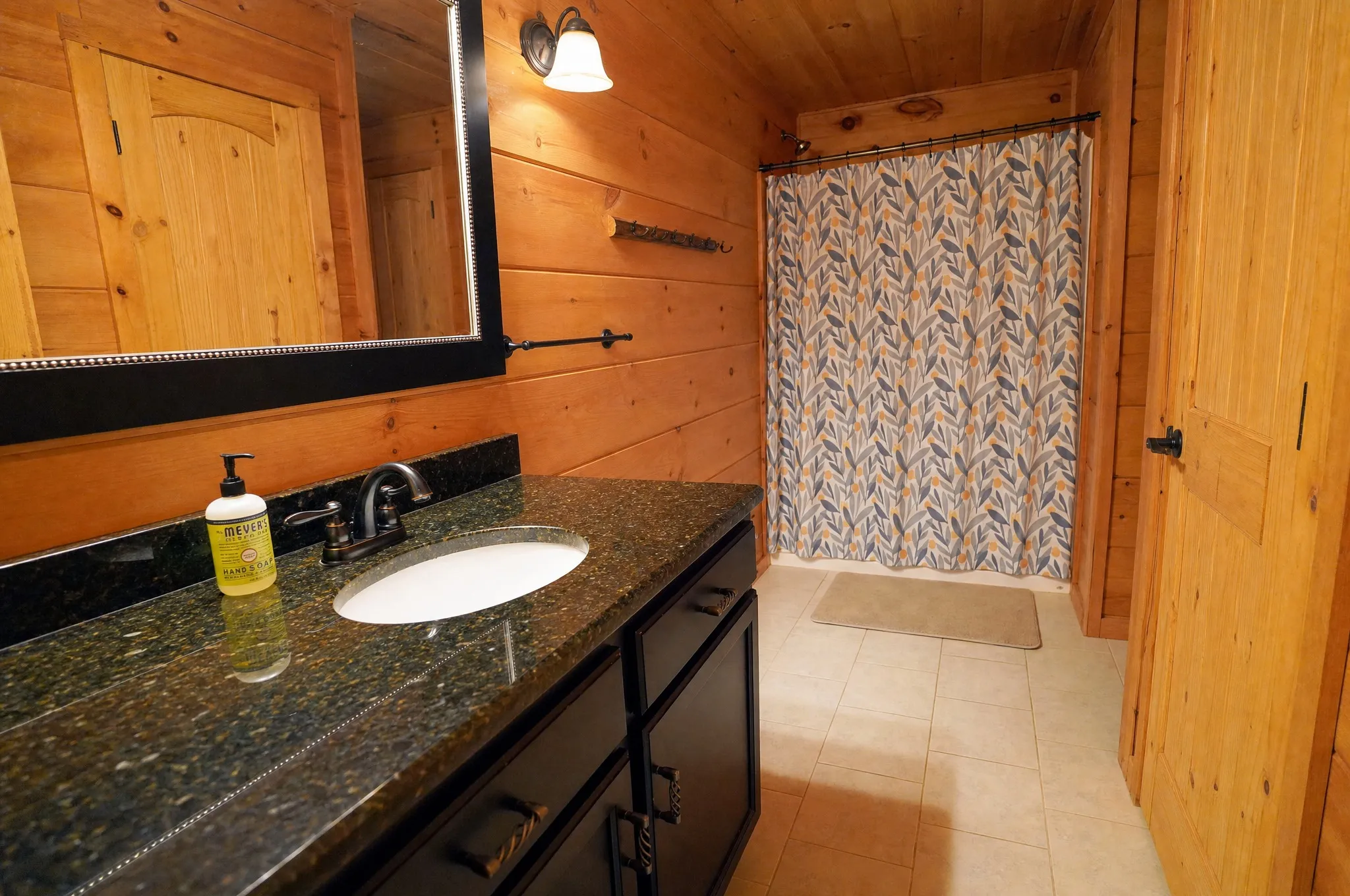 Remodeled bathroom with a long vanity and tub-shower