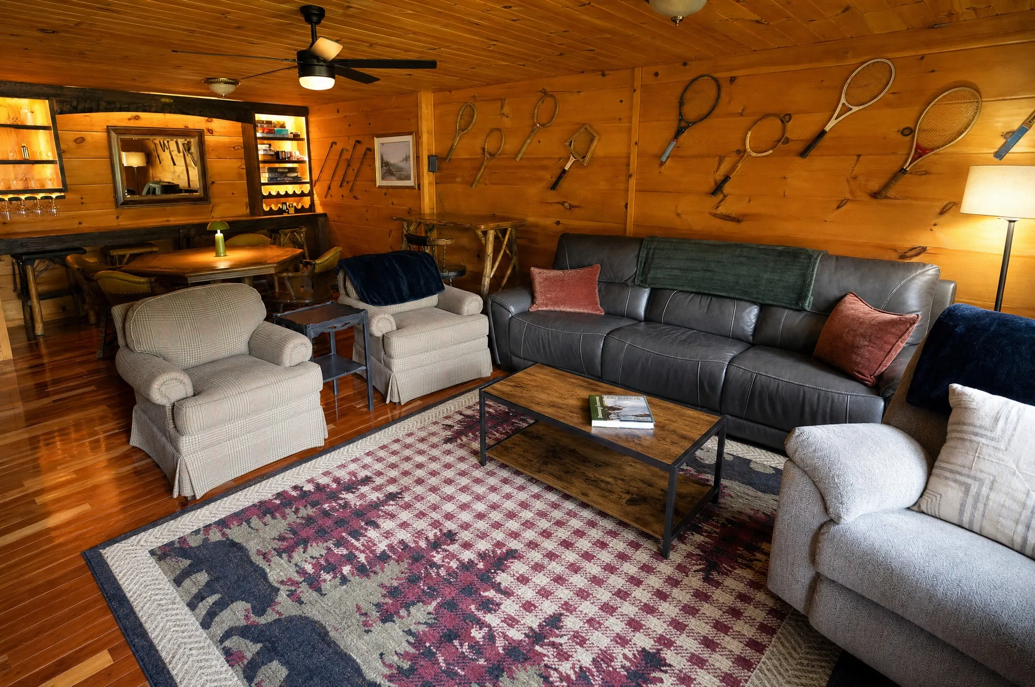 Rec room lounge with a leather sofa and mountain wall art