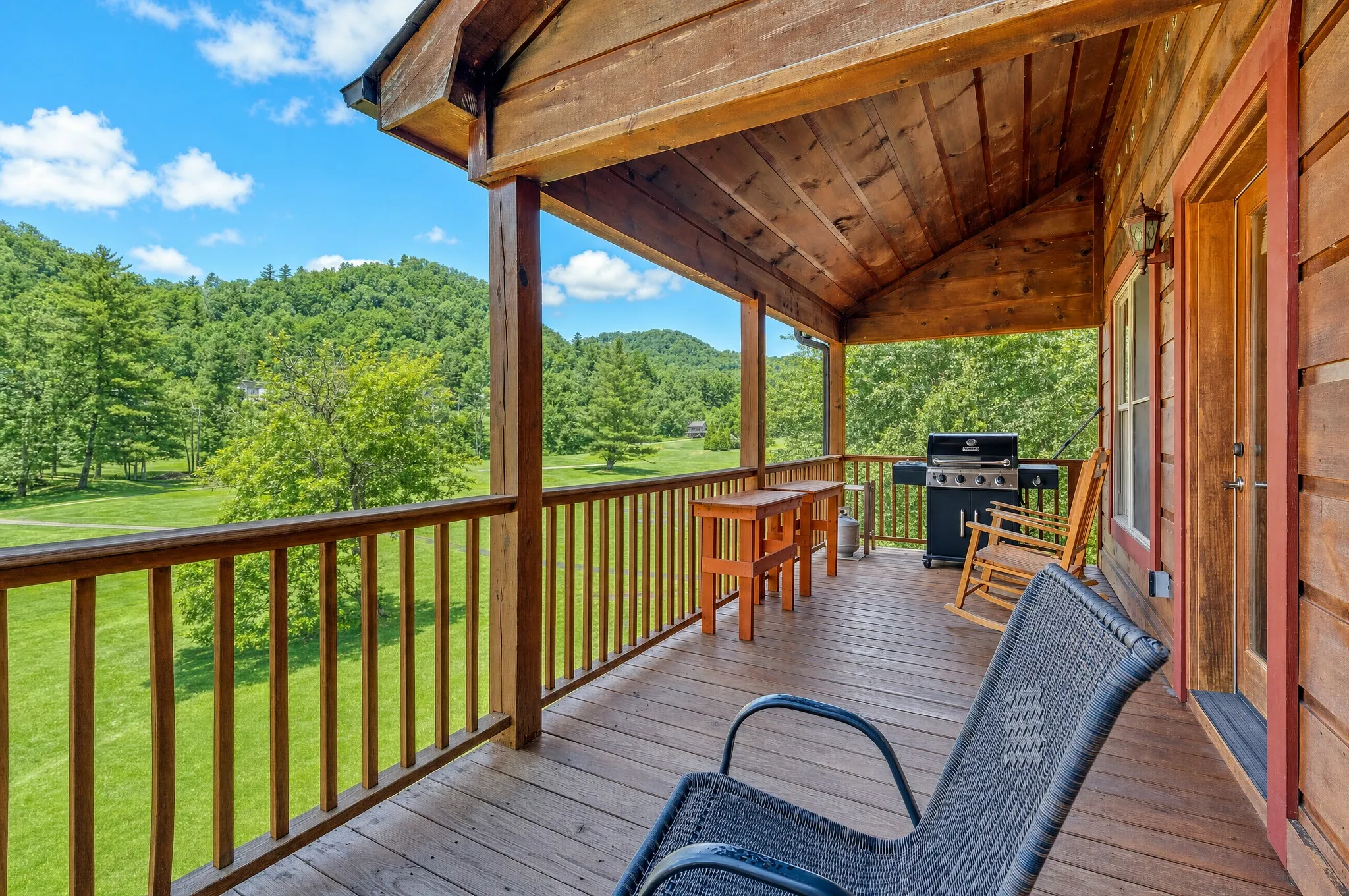 Covered deck with a grill and rocking chairs