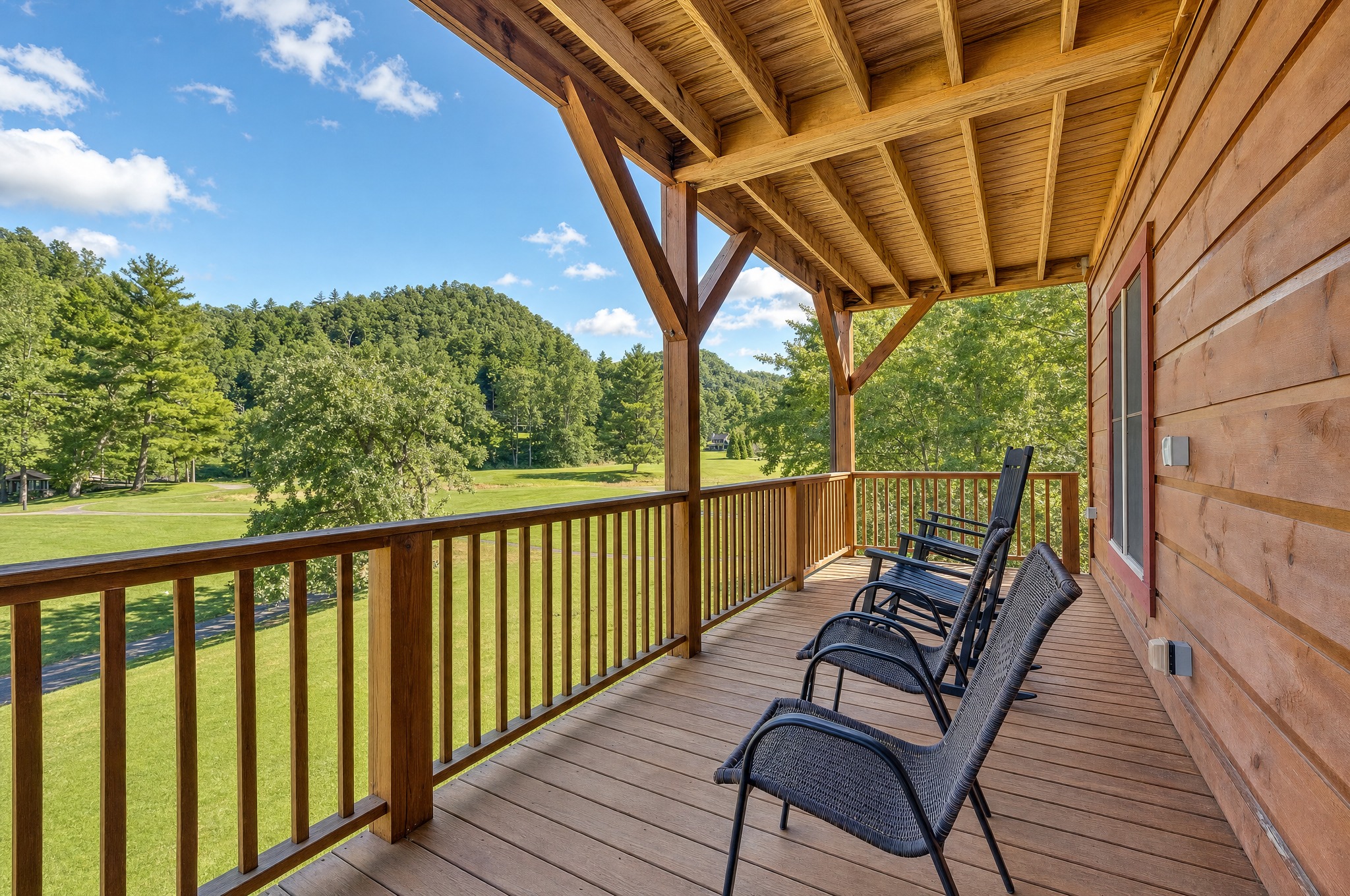 Covered deck with chairs and a Blue Ridge valley view