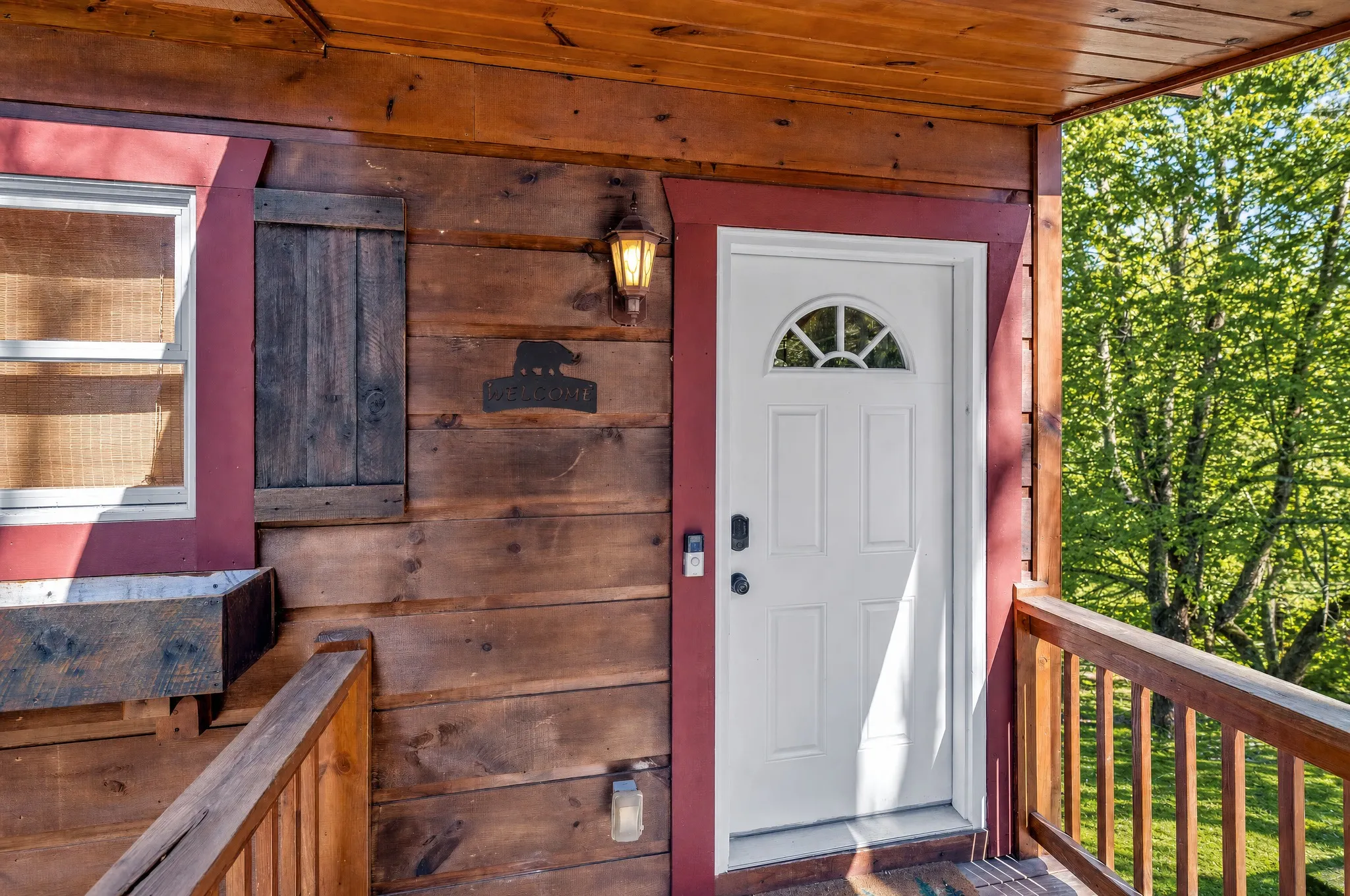 Front door of the cabin off the covered porch